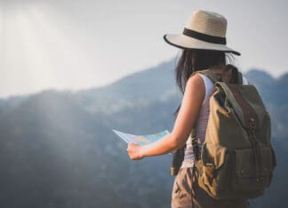 An Invitation to Dream activity young woman watching binoculars in nature park , Tourist traveler backpack Happy and freedom with copy space ,travel concept.