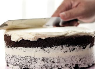 Nana’s Black Chocolate Coffee Cake for Christmas! Spreading white butter cream on homemade chocolate cake.