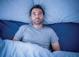 Just One Good Night of Sleep Anxious man trying to sleep but suffering insomnia