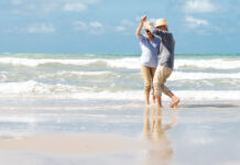 Senior couple dancing on beach
