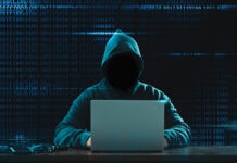 Big financial data theft concept. An anonymous hacker is hacking highly-protected financial data through computers.