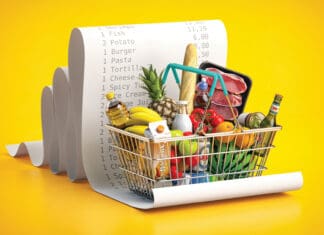 Back to Basics Shopping basket with foods on receipt. Grocery expenses budget, inflation and consumerism concept.