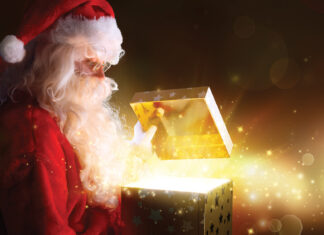 Traditional Santa Claus With Gifts And Sparkle Stars