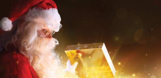 Traditional Santa Claus With Gifts And Sparkle Stars