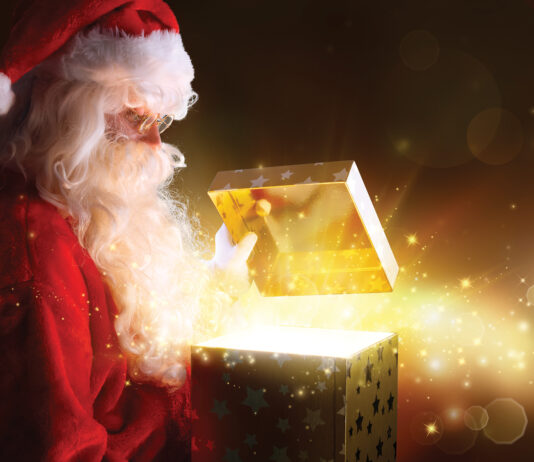 Traditional Santa Claus With Gifts And Sparkle Stars