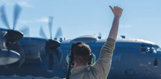 A 4th Special Operations Maintenance Squadron Airman directs a 4th Special Operations Squadron AC-130J Ghostrider gunship, as it prepares to taxi at Hurlburt Field, Florida, Dec. 4, 2024. The aircraft was used in a Next Generation Aircrew Protection team test to evaluate the effectiveness of chemical stimulant vapor purge systems during flight. (U.S. Air Force photo by Airman Samantha Rossi)