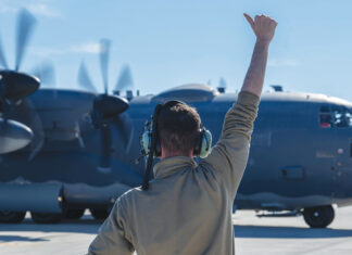 A 4th Special Operations Maintenance Squadron Airman directs a 4th Special Operations Squadron AC-130J Ghostrider gunship, as it prepares to taxi at Hurlburt Field, Florida, Dec. 4, 2024. The aircraft was used in a Next Generation Aircrew Protection team test to evaluate the effectiveness of chemical stimulant vapor purge systems during flight. (U.S. Air Force photo by Airman Samantha Rossi)