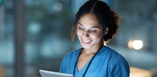 Nurse, medical tablet and black woman in hospital working late on telehealth, research or online consultation. Tech, healthcare or female physician with technology for wellness app in clinic at night