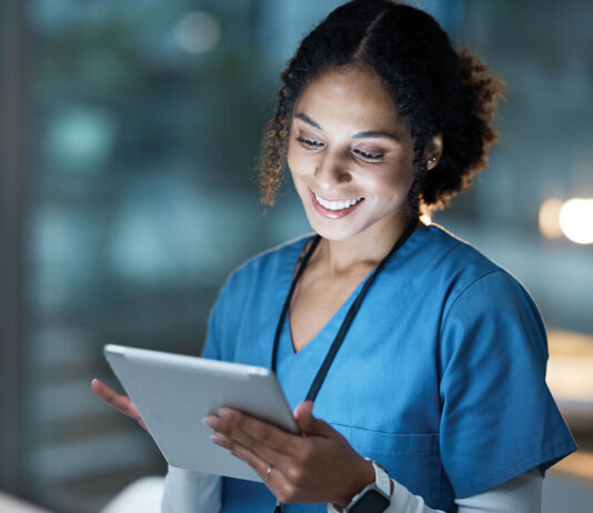 Nurse, medical tablet and black woman in hospital working late on telehealth, research or online consultation. Tech, healthcare or female physician with technology for wellness app in clinic at night