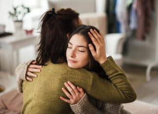 Bring Hope Now: Local Nonprofit Aims to Solve Youth Mental Health Crisis Teenager Hugging Parent iStock 1476266423