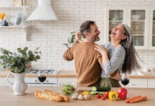 It’s Time to Exercise Happy Couple in Kitchen iStock 1328351784